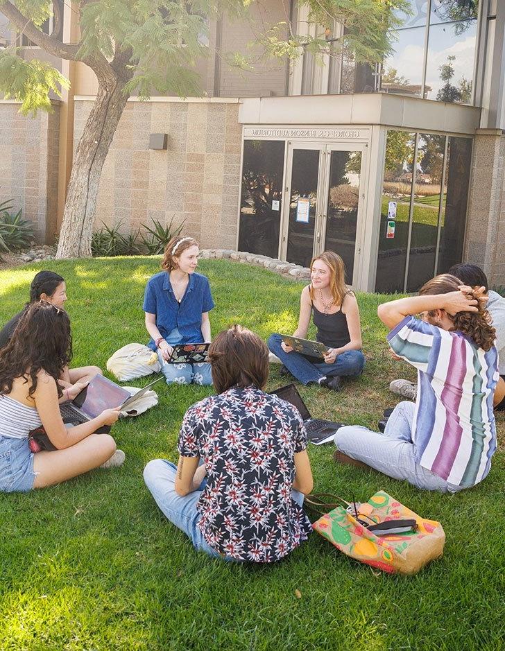 a study group sits in a circle on the mounds